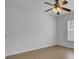 Simple bedroom with hardwood floors, ceiling fan, and large window with blinds at 124 Sweet Alyssum Dr, Ladson, SC 29456