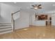 Bright living room with hardwood floors and an open concept design, showcasing staircase and kitchen at 124 Sweet Alyssum Dr, Ladson, SC 29456