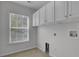 Bright laundry room with white cabinets and window at 124 Sweet Alyssum Dr, Ladson, SC 29456