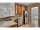 Kitchen boasts stainless steel appliances, wood cabinets, and granite countertops at 124 Sweet Alyssum Dr, Ladson, SC 29456