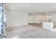 Open living room with grey carpet and kitchen view at 4383 Ocean Farm Dr, Summerville, SC 29485