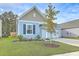 Newly built home with light blue siding, white garage door, and landscaped front yard at 4383 Ocean Farm Dr, Summerville, SC 29485