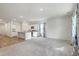 Spacious living room with grey carpet and access to the kitchen at 4383 Ocean Farm Dr, Summerville, SC 29485