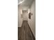 Long hallway with wood-look flooring and neutral walls at 4383 Ocean Farm Dr, Summerville, SC 29485