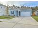 Newly built home with light blue siding, white garage door, and landscaped front yard at 4383 Ocean Farm Dr, Summerville, SC 29485