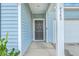 Light blue house with a gray roof, white garage door, and landscaping at 4383 Ocean Farm Dr, Summerville, SC 29485