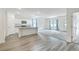 Open concept kitchen and living room with island and wood-look flooring at 4383 Ocean Farm Dr, Summerville, SC 29485