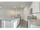 Modern kitchen with white cabinets, granite countertops, and stainless steel appliances at 4383 Ocean Farm Dr, Summerville, SC 29485