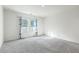 Spacious bedroom with grey carpet and two windows with blue curtains at 4383 Ocean Farm Dr, Summerville, SC 29485