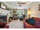 Living room with fireplace, ceiling fan, and ample natural light at 1135 Harborgate Dr, Mount Pleasant, SC 29464