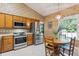 Bright kitchen with oak cabinets, stainless steel appliances, and a charming eat-in area at 1135 Harborgate Dr, Mount Pleasant, SC 29464