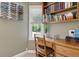 Home office with built-in shelving, a wood desk, and a view of the backyard at 1135 Harborgate Dr, Mount Pleasant, SC 29464