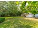 Large backyard with detached garage and lush trees at 1135 Harborgate Dr, Mount Pleasant, SC 29464