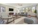 Spacious living room with gray sofa and armchairs, and large windows at 135 Dantzler Rd, Harleyville, SC 29448