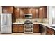 Kitchen features stainless steel appliances and dark wood cabinets at 157 Collared Dove Ct, Summerville, SC 29483