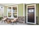 Inviting front porch with wicker chairs and small side table at 157 Collared Dove Ct, Summerville, SC 29483