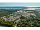 Aerial view of a new coastal community featuring houses, landscaping, and a lake at 1659 Cultivation Ln # 454, Mount Pleasant, SC 29466