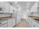 Galley kitchen with white cabinets and new appliances at 330 Concord St # 5 A, Charleston, SC 29401