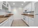 White kitchen cabinets, tile floors, and modern appliances at 330 Concord St # 5 A, Charleston, SC 29401