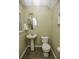 Clean half bathroom with pedestal sink and dark tile floor at 5150 Trump St # 1404, North Charleston, SC 29420