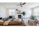 Living room with a comfortable sectional sofa, fireplace, and large windows at 383 Wappoo Trace Ln, Summerville, SC 29486