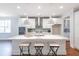Modern kitchen with a large island, white cabinets, and stainless steel appliances at 383 Wappoo Trace Ln, Summerville, SC 29486