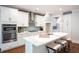 White kitchen with stainless steel appliances and a spacious island with seating at 383 Wappoo Trace Ln, Summerville, SC 29486