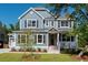 Two-story home with gray siding, metal roof, and front porch at 383 Wappoo Trace Ln, Summerville, SC 29486