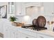 White kitchen with gas cooktop and herringbone tile at 1661 Siloh Dr # 492, Mount Pleasant, SC 29466