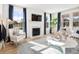 Bright living room with a fireplace, large windows, and a cozy sitting area at 1661 Siloh Dr # 492, Mount Pleasant, SC 29466