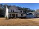 Two-story farmhouse with stone accents and detached garage at 517 Rendezvous Way, Huger, SC 29450