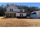 Two-story farmhouse with stone accents and detached garage at 517 Rendezvous Way, Huger, SC 29450