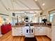 Open kitchen with white cabinets, oven, and view into the living area at 8541 Oyster Factory Rd, Edisto Island, SC 29438