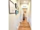 Bright hallway with hardwood floors and framed artwork at 8541 Oyster Factory Rd, Edisto Island, SC 29438