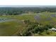 Aerial view showing home's waterfront location and lush surroundings at 8541 Oyster Factory Rd, Edisto Island, SC 29438