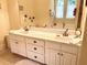 Double vanity bathroom with large mirror and a view of the garden at 8541 Oyster Factory Rd, Edisto Island, SC 29438