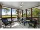 Spacious screened porch with wicker furniture and tranquil water views at 8541 Oyster Factory Rd, Edisto Island, SC 29438