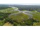 Aerial view showcasing home's waterfront location and marsh at 8541 Oyster Factory Rd, Edisto Island, SC 29438