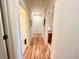 Bright hallway with hardwood floors and access to bedrooms and bathrooms at 8541 Oyster Factory Rd, Edisto Island, SC 29438