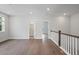Bright upper hall with hardwood floors, built-in shelving, and access to bedrooms and bath at 1400 Dahlia Rd, Mount Pleasant, SC 29464