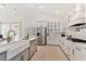Modern kitchen with white cabinets, farmhouse sink, and stainless steel appliances at 130 Cantona Dr, Summerville, SC 29483