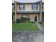 Brick front of a townhome with landscaping and walkway at 5729 Dewsbury Ln, North Charleston, SC 29418