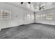 Bright bonus room with grey carpeting, ceiling fan and multiple windows at 1144 Old Mill Rd, Saint Stephen, SC 29479