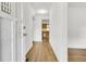 Light-filled entryway with wood-look floors leading to kitchen at 1144 Old Mill Rd, Saint Stephen, SC 29479