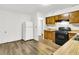 White appliances and wood cabinets in this kitchen at 1144 Old Mill Rd, Saint Stephen, SC 29479