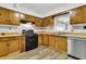 Wood cabinets and gas range in this well-lit kitchen at 1144 Old Mill Rd, Saint Stephen, SC 29479