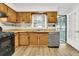 Cozy kitchen featuring wood cabinets, vinyl flooring, and a view to the backyard at 1144 Old Mill Rd, Saint Stephen, SC 29479