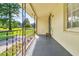 Covered porch with wrought iron railing offering a view of the yard at 1144 Old Mill Rd, Saint Stephen, SC 29479