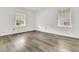Bright bedroom with grey vinyl flooring and two windows at 1144 Old Mill Rd, Saint Stephen, SC 29479