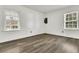 Spacious bedroom with grey vinyl flooring and two windows at 1144 Old Mill Rd, Saint Stephen, SC 29479